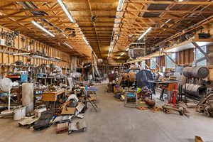 Miscellaneous room with concrete flooring and a workshop area