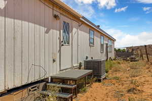 View of side of property with a central AC unit