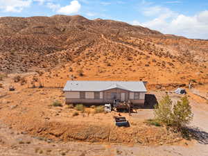 View of rural area with a mountain backdrop and a desert landscape