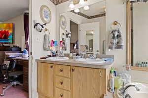 Bathroom featuring double vanity, a textured ceiling, and a bath