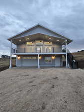 View of front facade with driveway, stairway, and a patio area