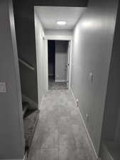 Hall with baseboards and stairs