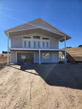 View of front of house with driveway and stairway