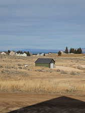View of yard with an outbuilding and a rural view