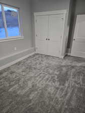 Unfurnished bedroom featuring a closet and carpet