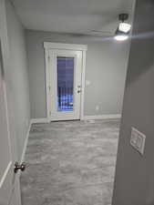 Entryway with baseboards and a ceiling fan