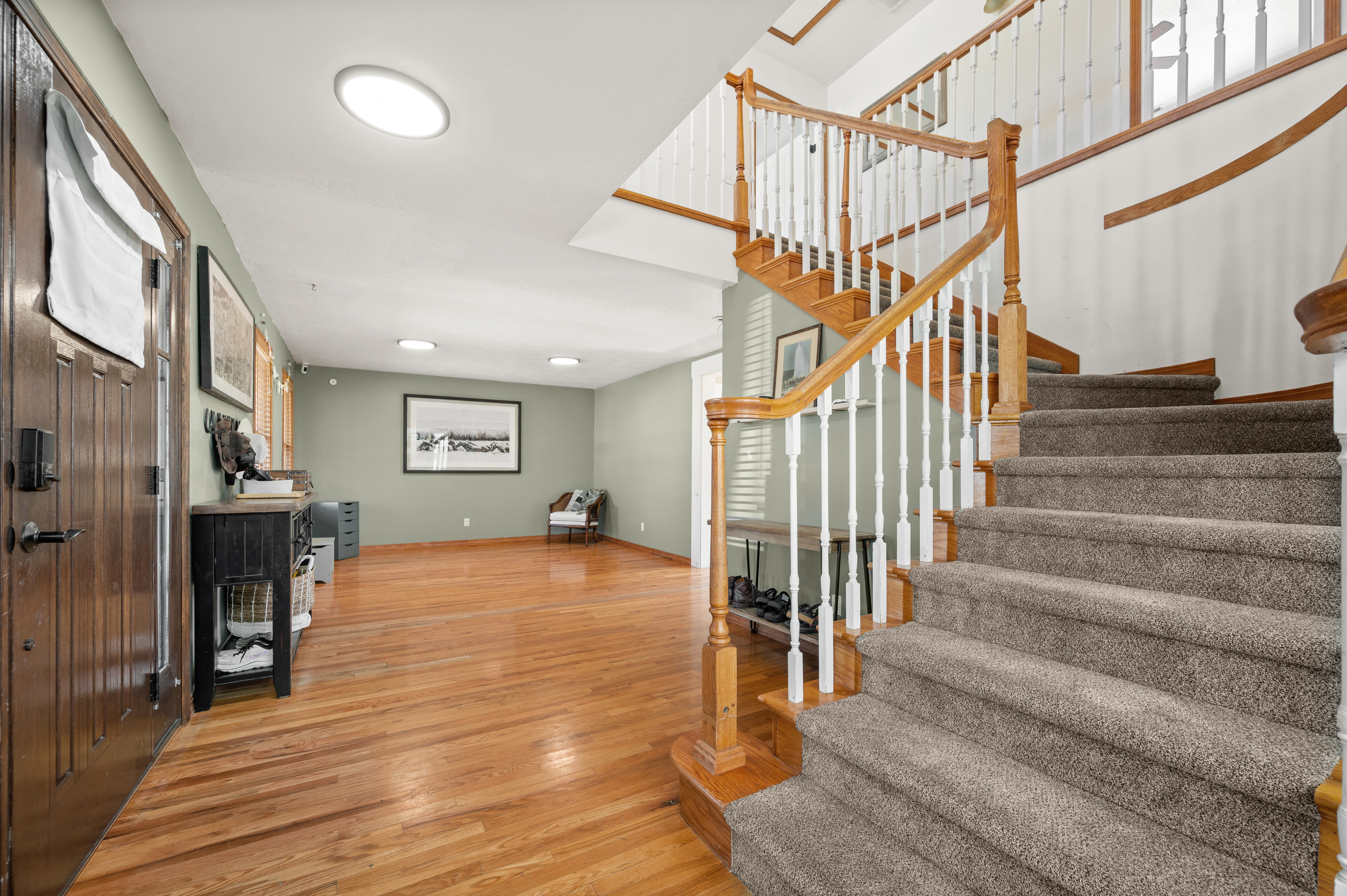 Shot of stairs and the Front door with Living room in the background