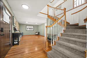 Shot of stairs and the Front door with Living room in the background