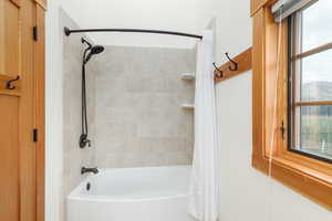 Full bathroom with shower / bathtub combination with curtain