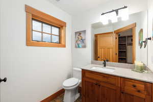 Half bathroom with vanity and toilet