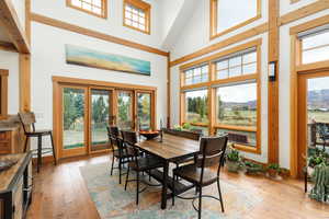 Dining area with a high ceiling and light wood finished floors