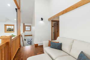 Living area featuring wood finished floors, recessed lighting, and high vaulted ceiling