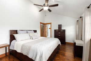 Bedroom featuring dark wood-style floors, ceiling fan, and high vaulted ceiling