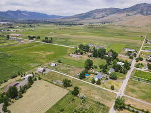 Aerial view of property and surrounding area with rural landscape and a mountain backdrop
