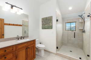 Bathroom featuring vanity, a shower stall, and light tile patterned floors