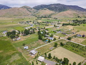 Aerial overview of property's location with rural landscape and a mountain backdrop
