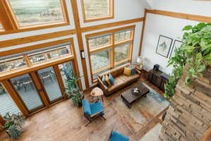 Living area with a towering ceiling and wood finished floors