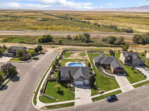 Aerial view of property and surrounding area featuring mountains