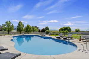 View of swimming pool with a fenced backyard, a patio area, a mountain view, and a diving board