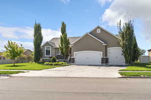 View of front of property with stucco siding, driveway, and an attached garage