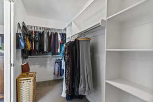 Walk in closet featuring carpet