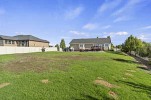 Back of house featuring a fenced backyard and a patio