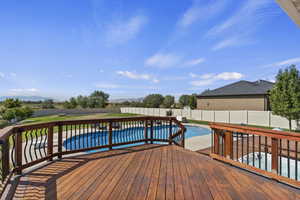 Wooden terrace featuring a patio and a fenced backyard