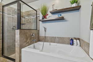 Bathroom with a bath and a shower stall