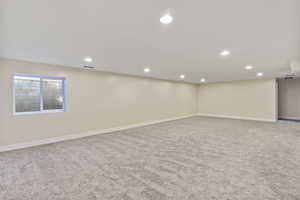 Basement with light colored carpet and recessed lighting