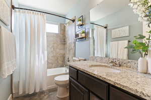 Bathroom featuring shower / bath combo and vanity