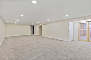 Below grade area with recessed lighting and light carpet