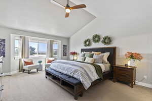 Carpeted bedroom featuring lofted ceiling and ceiling fan