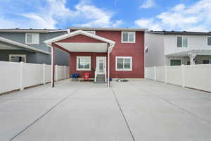 Back of property featuring a patio, stucco siding, a fenced backyard, and entry steps