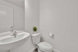 Bathroom with toilet and baseboards