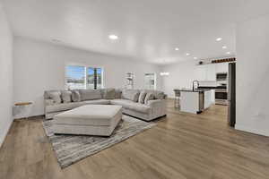 Living area featuring a chandelier, recessed lighting, and light wood-style flooring