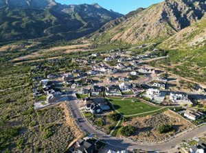 Aerial view of property's location with a mountain backdrop and nearby suburban area