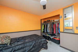 Bedroom featuring carpet, a closet, and a ceiling fan