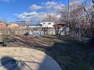 Fenced backyard featuring a gazebo and a mountain view
