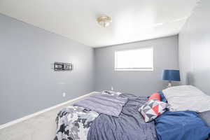 Bedroom with carpet flooring and baseboards