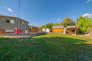 View of yard with a shed and a patio