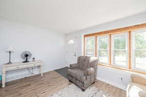 Sitting room with light wood-style flooring and baseboards
