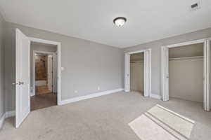 Second floor bedroom featuring two-tone paint, bay window, and carpeted flooring