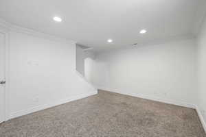 Basement living room with fresh paint, recessed lighting, and carpeted flooring