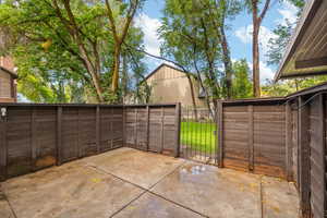 View of fenced patio featuring a gate
