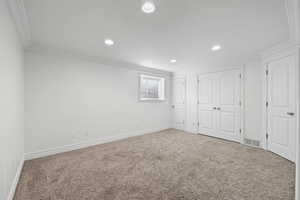 Basement living room with fresh paint, recessed lighting, and carpeted flooring