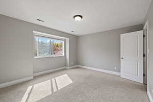 Second floor bedroom featuring two-tone paint, bay window, and carpeted flooring