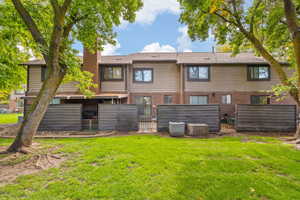Rear view of property featuring fenced in patio