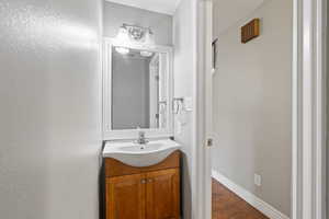 Bathroom featuring vanity and wood finished floors