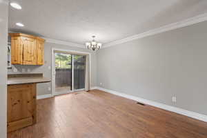 Dining area featuring laminate flooring, two tone paint, and patio access