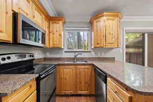 Kitchen featuring alder cabinets, quartz countertops, stainless steel appliances, recessed lighting and two-tone paint